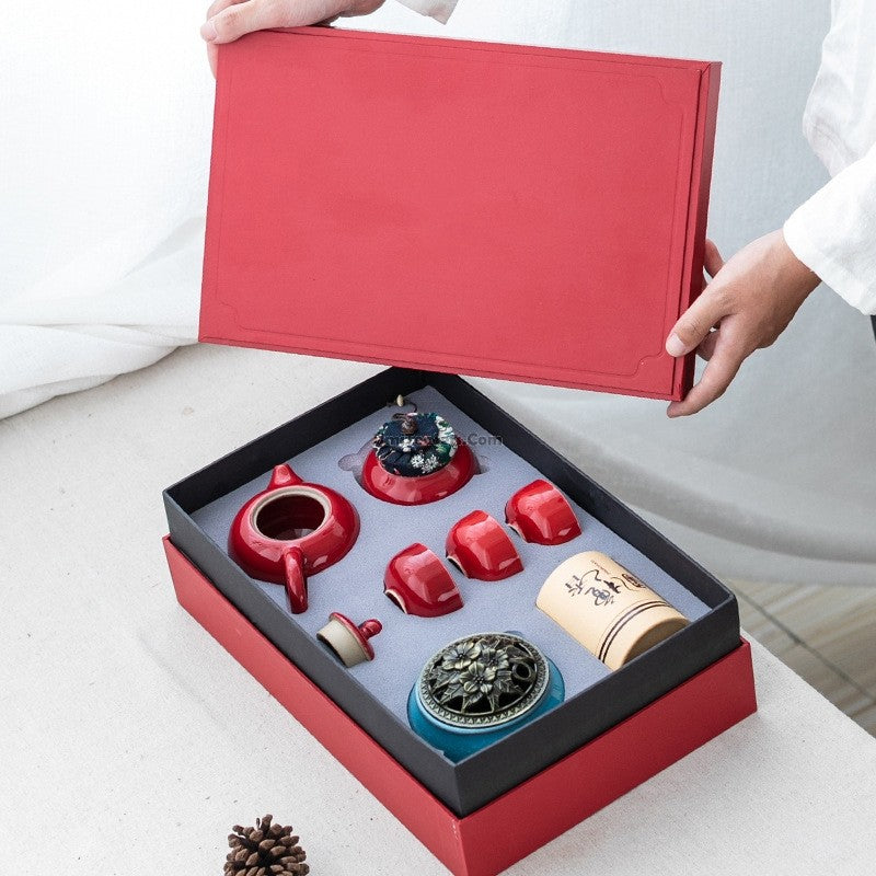 A tea set inside an open red box